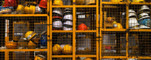 Lockers at a worksite with helmets in them.