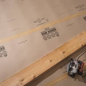 Ram board rolled out on a floor with a 2x4 on it