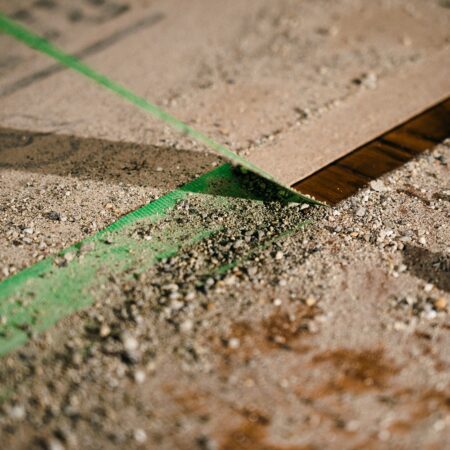 worker holding edge tape