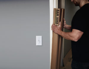 Door Jamb protector being placed around a door frame