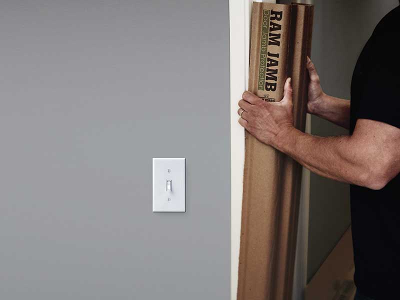 Door Jamb protector being placed around a door frame