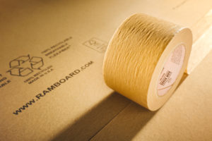 close up view of a roll of brown ram board seam tape on paperboard floor protection
