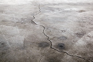 Cracks on a concrete garage floor.
