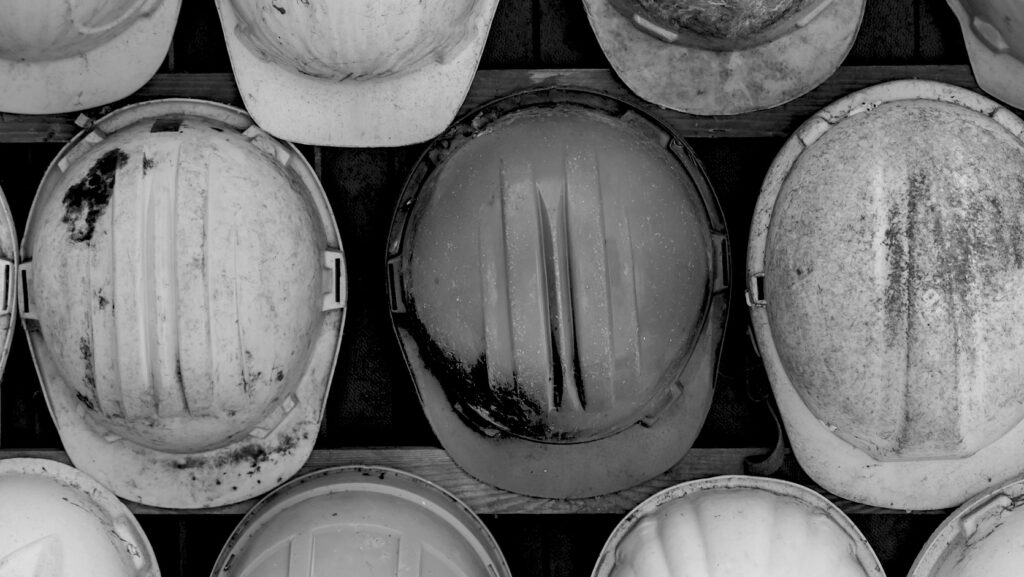 images descendantes en noir et blanc de casques de sécurité utilisés sur les chantiers de construction