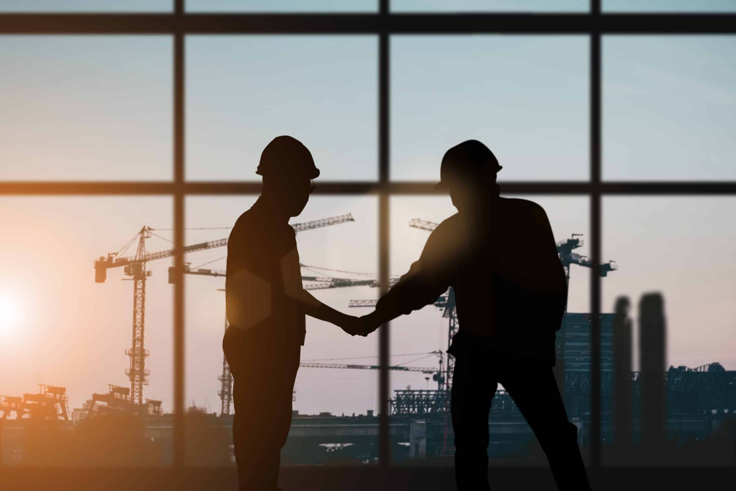 construction workers shaking hands