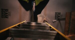 ram board with worker climbing a ladder