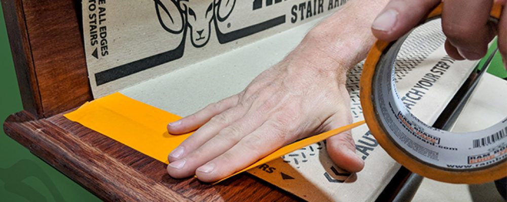 Stair armor being taped onto stairs